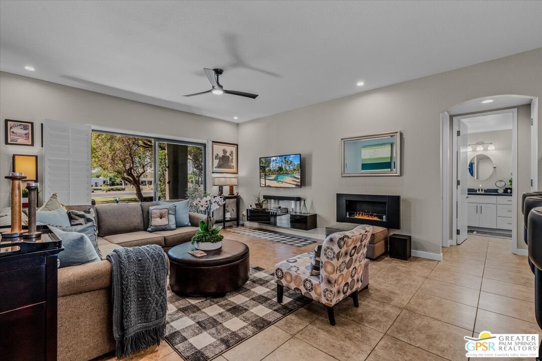 a living room with furniture and a fireplace