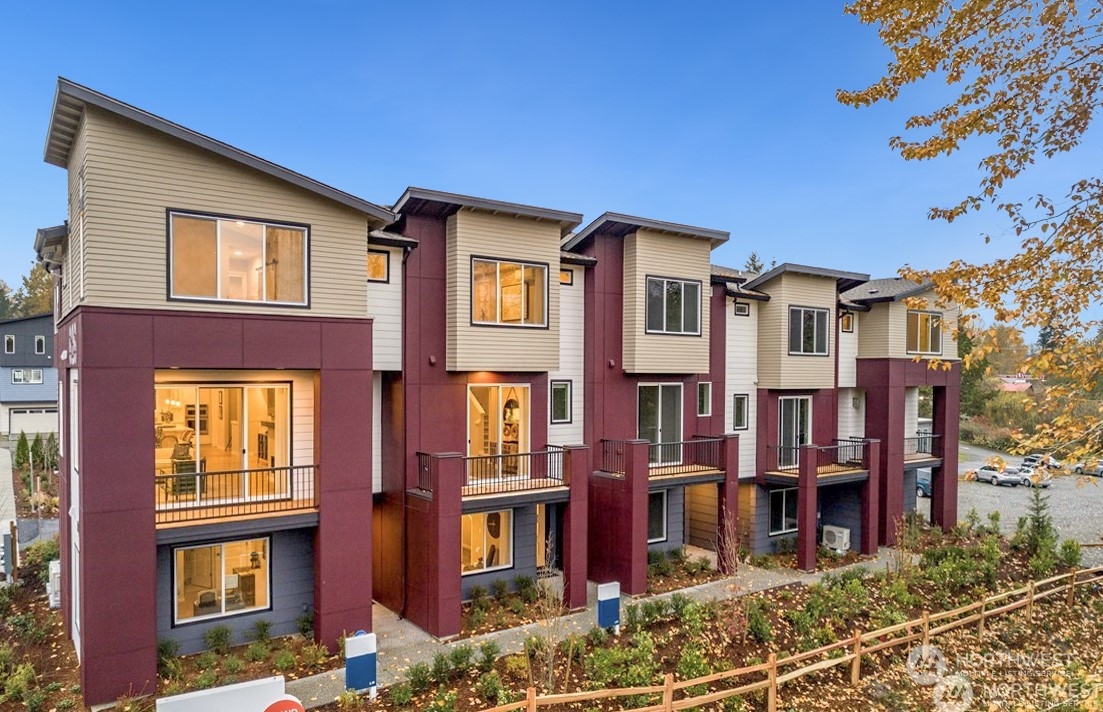 a front view of a residential apartment building with a yard