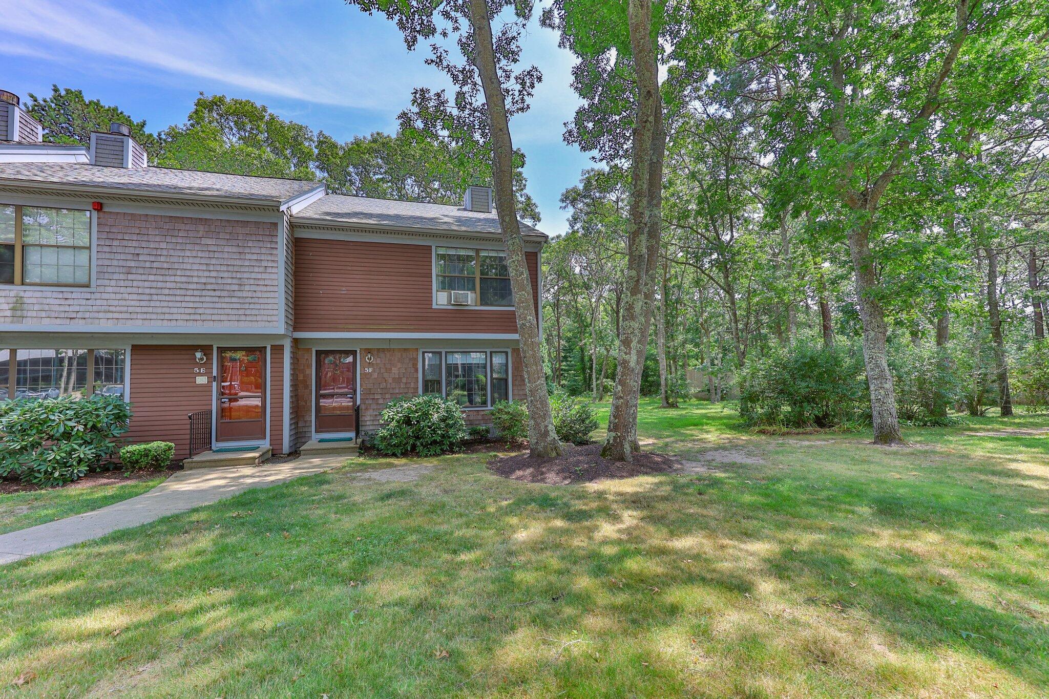 a view of a brick house with a yard