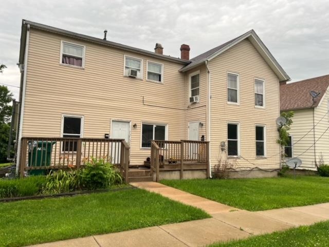 a front view of a house with a yard and porch