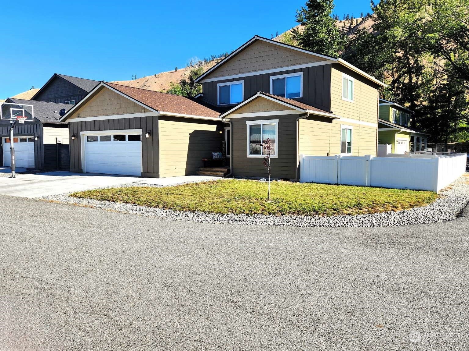 a front view of a house with a yard and garage