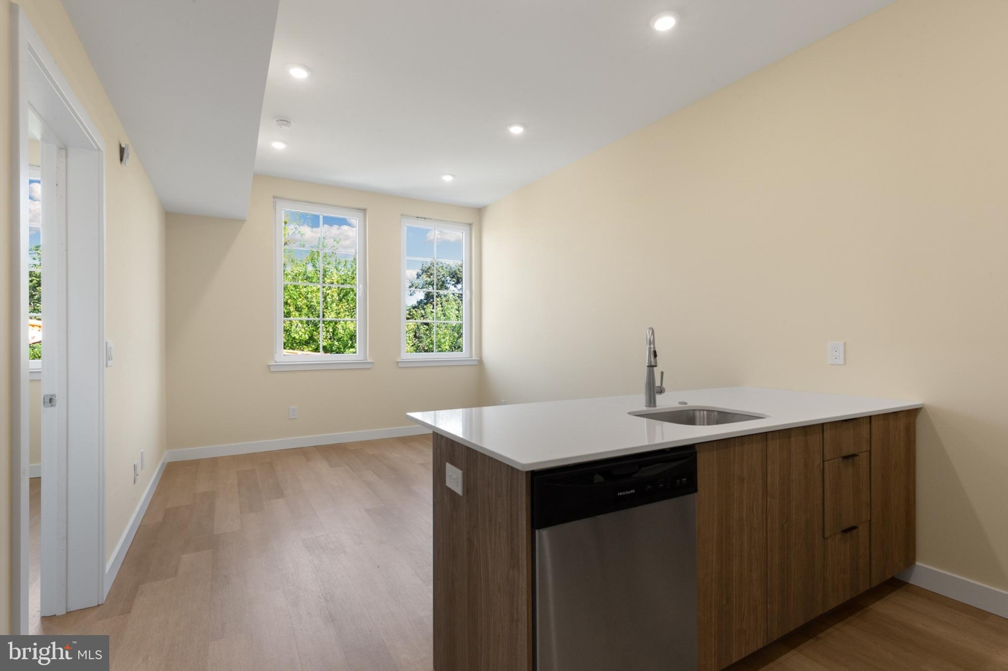 a kitchen with a sink cabinets and a window