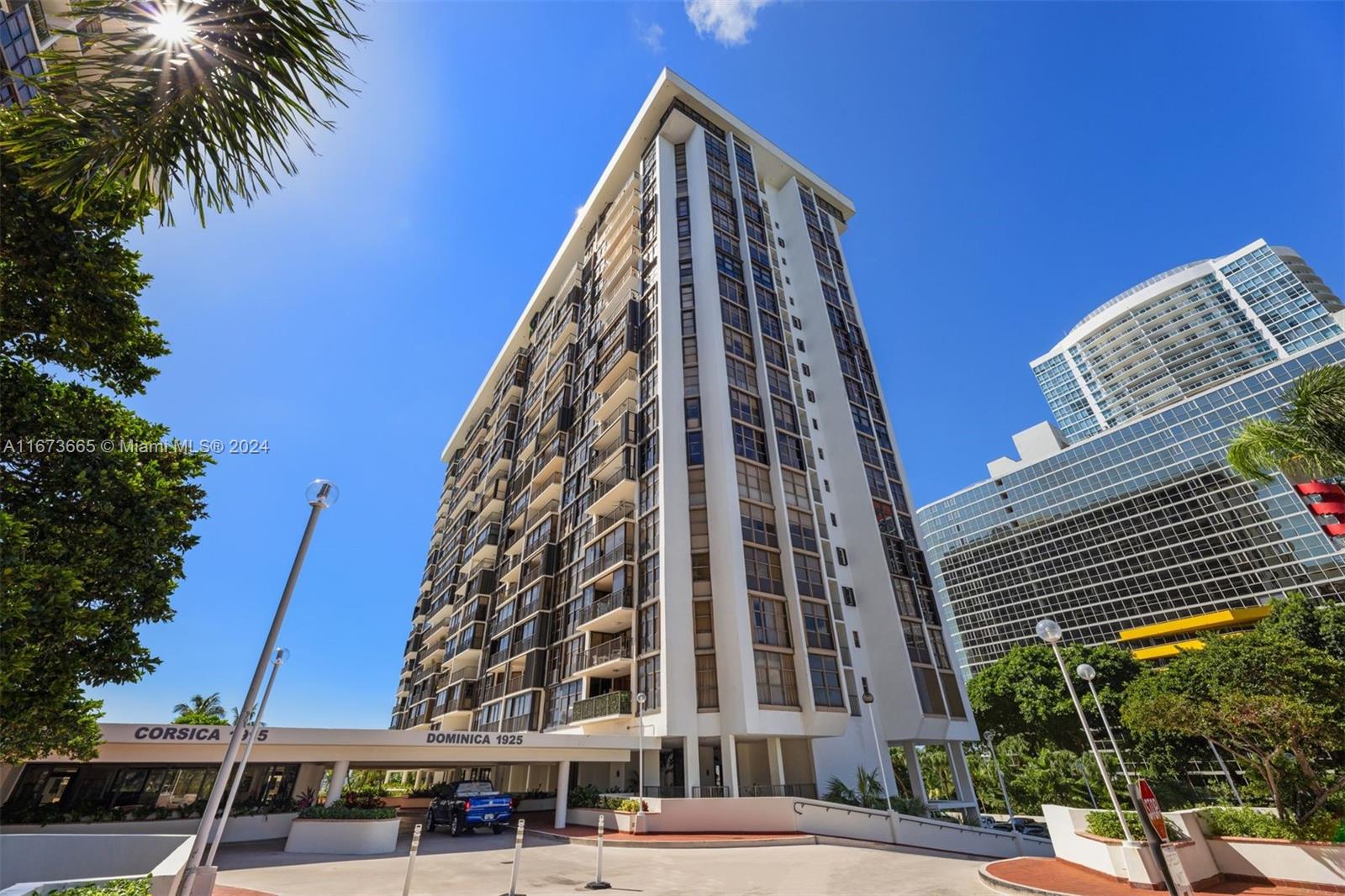 a view of a tall building next to a road