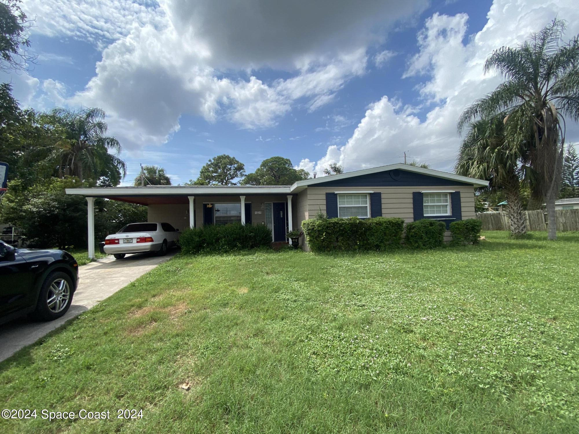 a front view of house with yard and green space