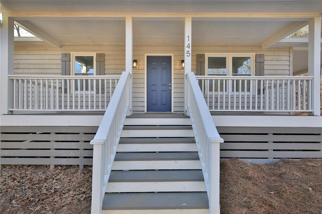 a view of entryway with stairs and wooden floor