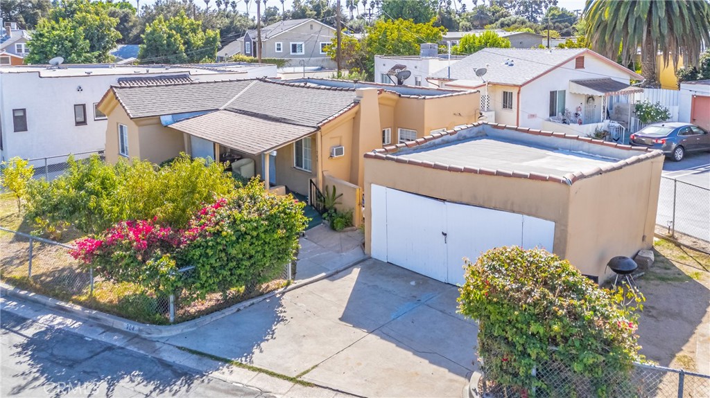 a aerial view of a house with yard and fountain in the background