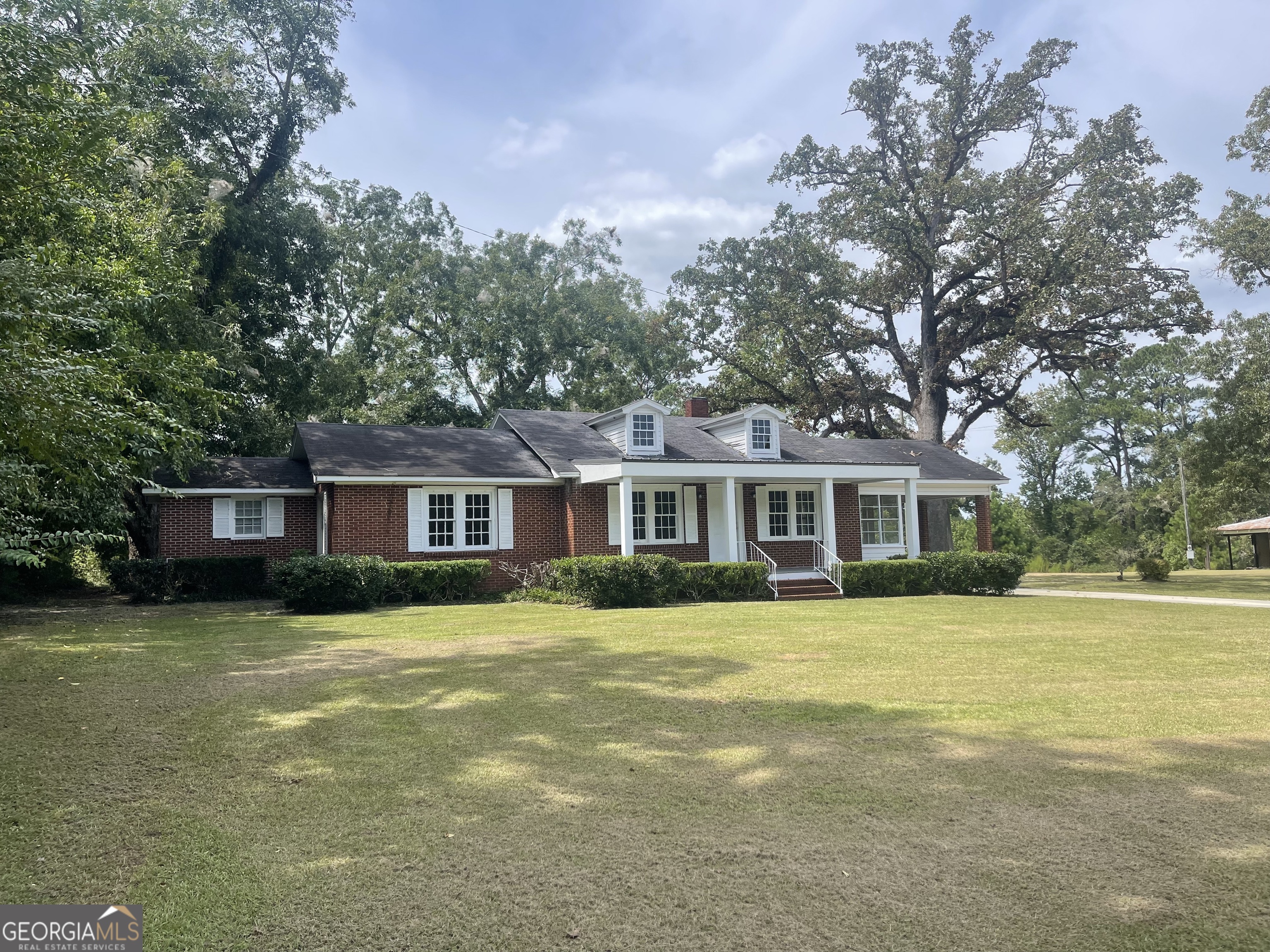 a front view of a house with a garden