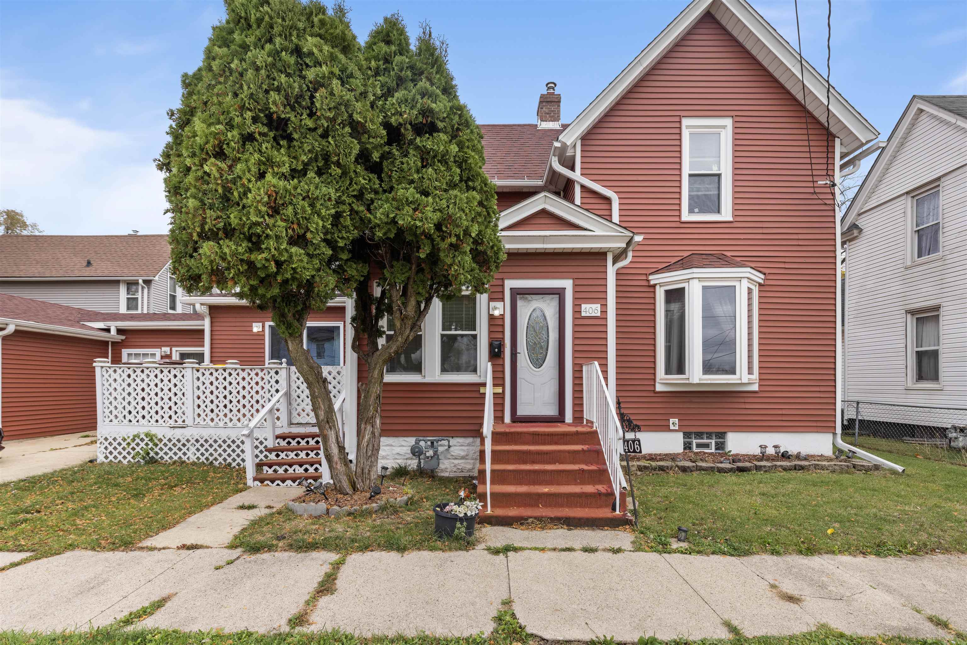 a front view of a house with a garden