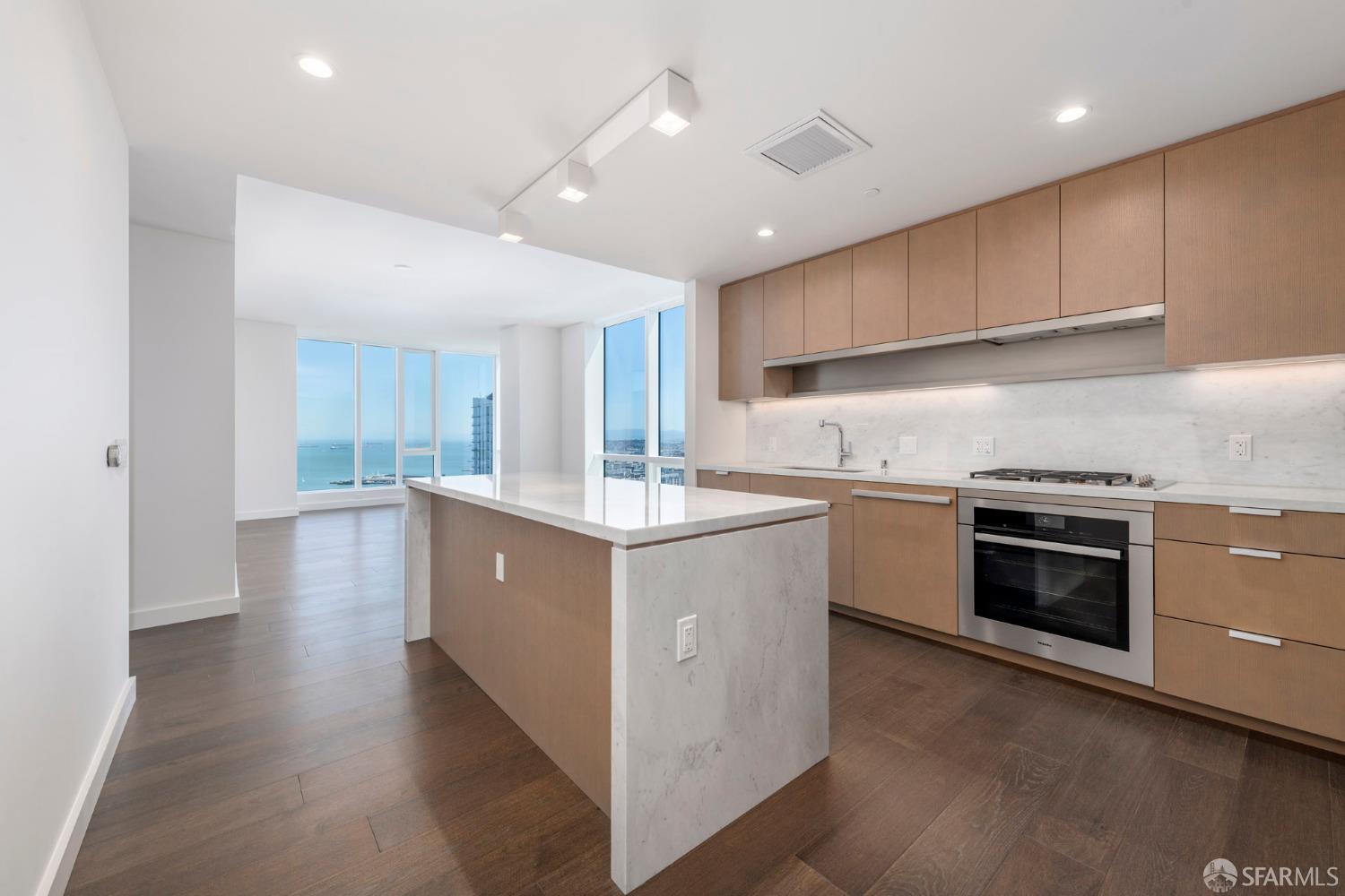 a kitchen with stainless steel appliances sink stove and cabinets