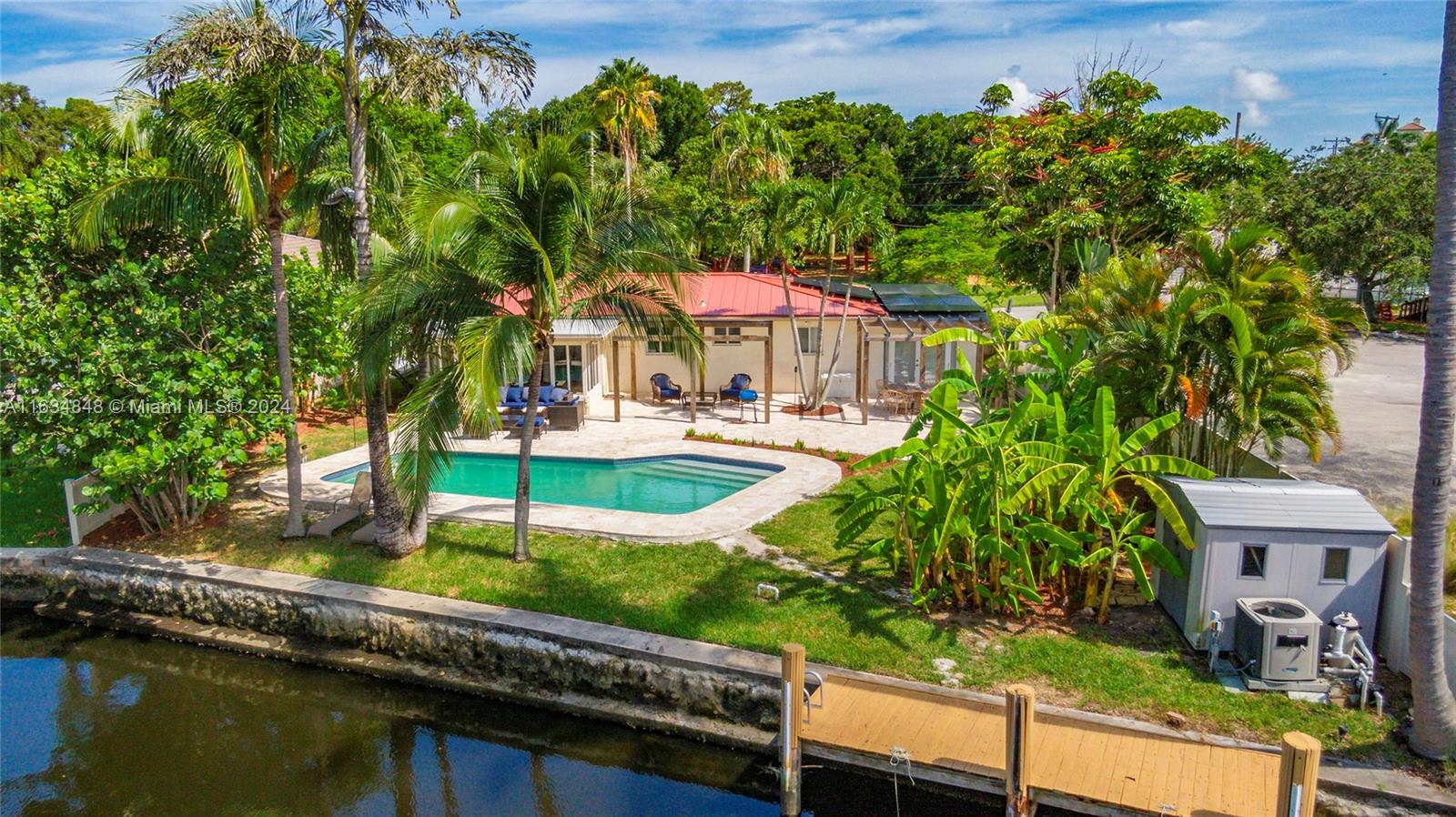 an outdoor view of the house with swimming pool