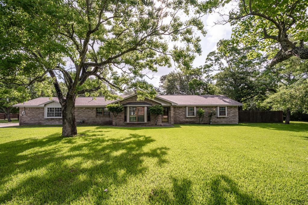 a front view of house with yard and trees