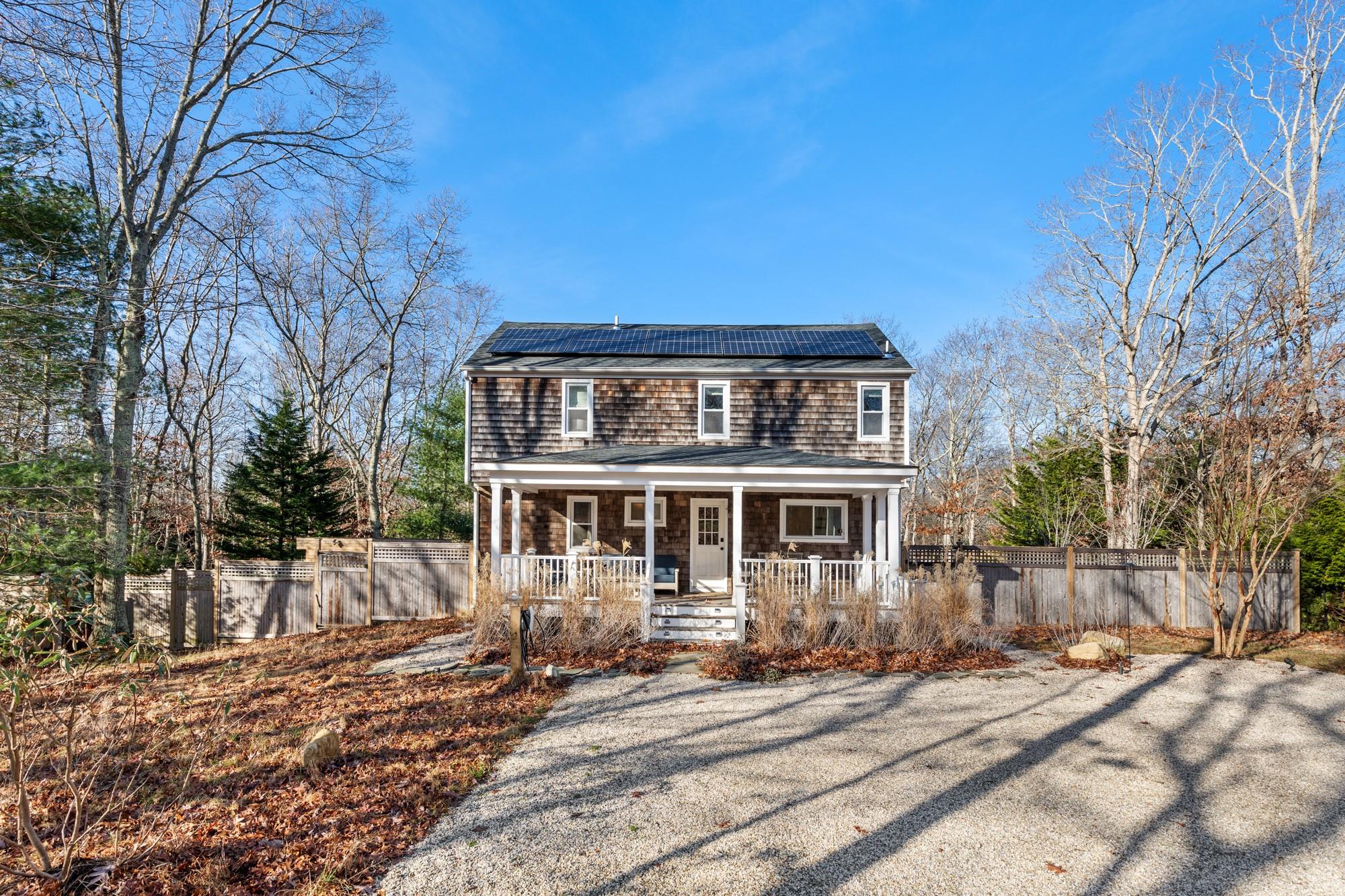 View of front of property featuring covered porch and solar panels