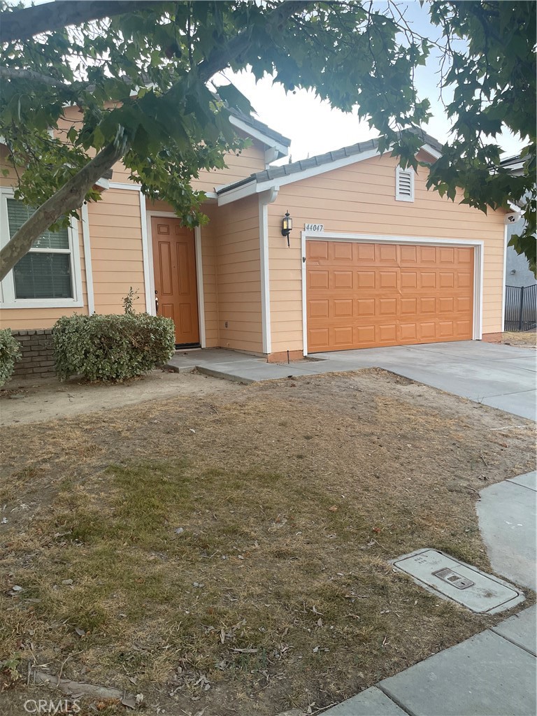 a view of a house with a yard and garage