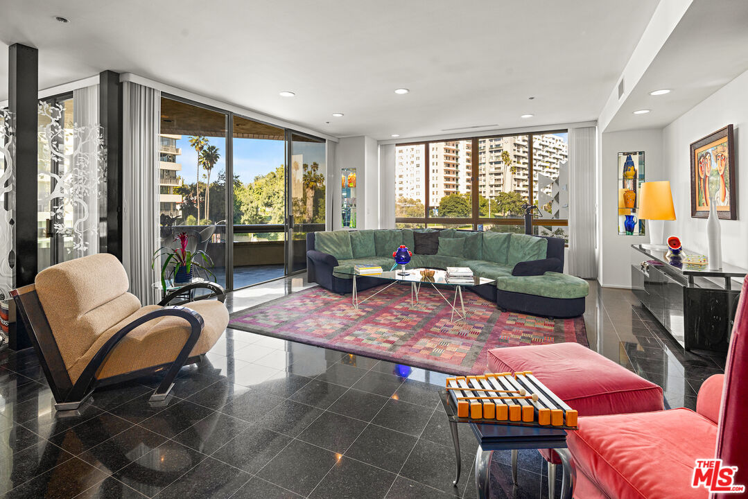 a living room with furniture a rug and a large window