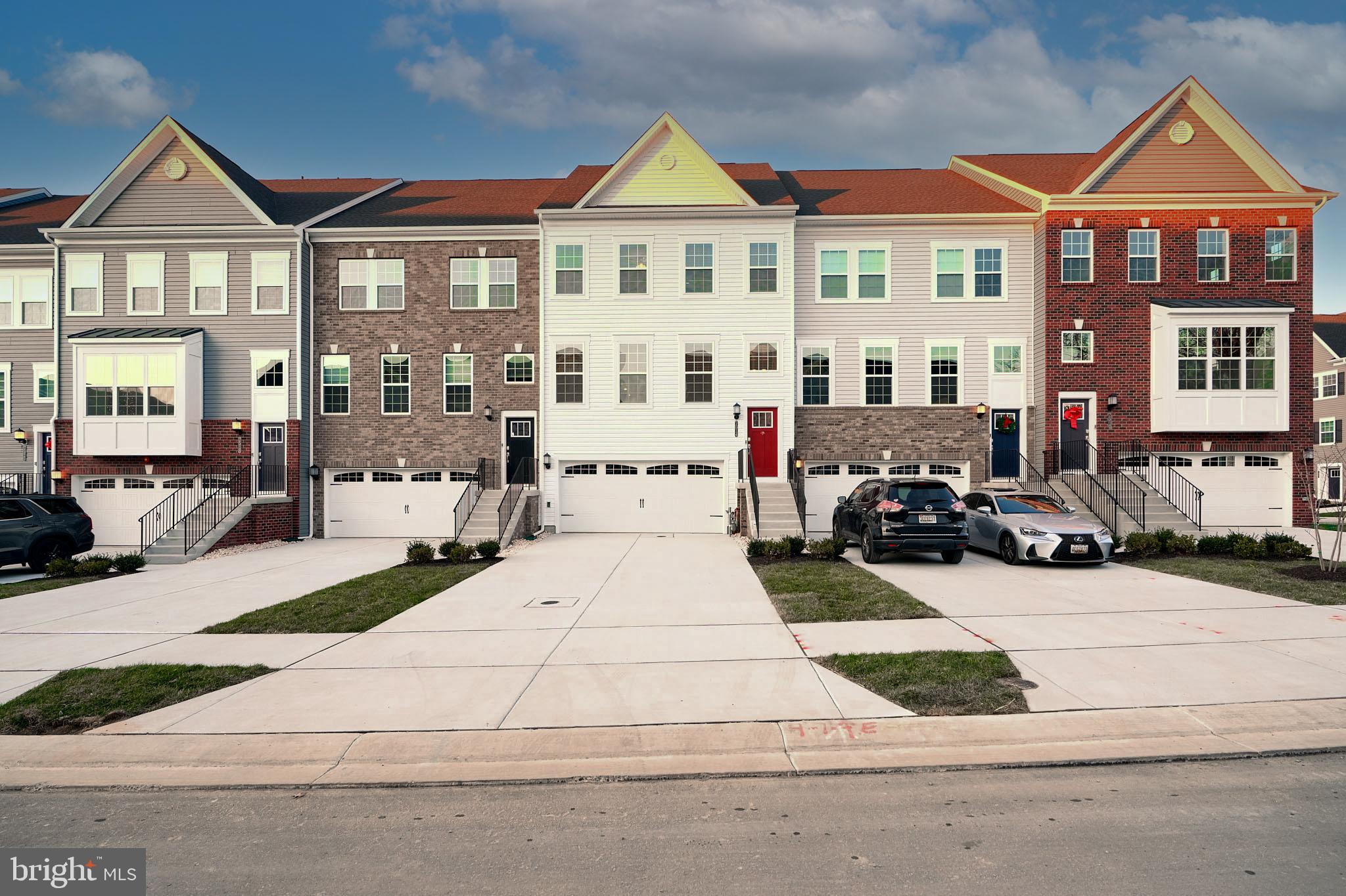 a view of a brick house with many windows and a yard