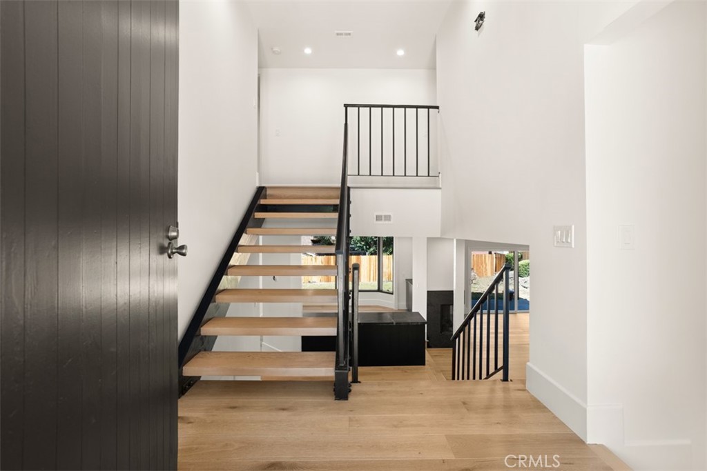 a view of entryway and hall with wooden floor