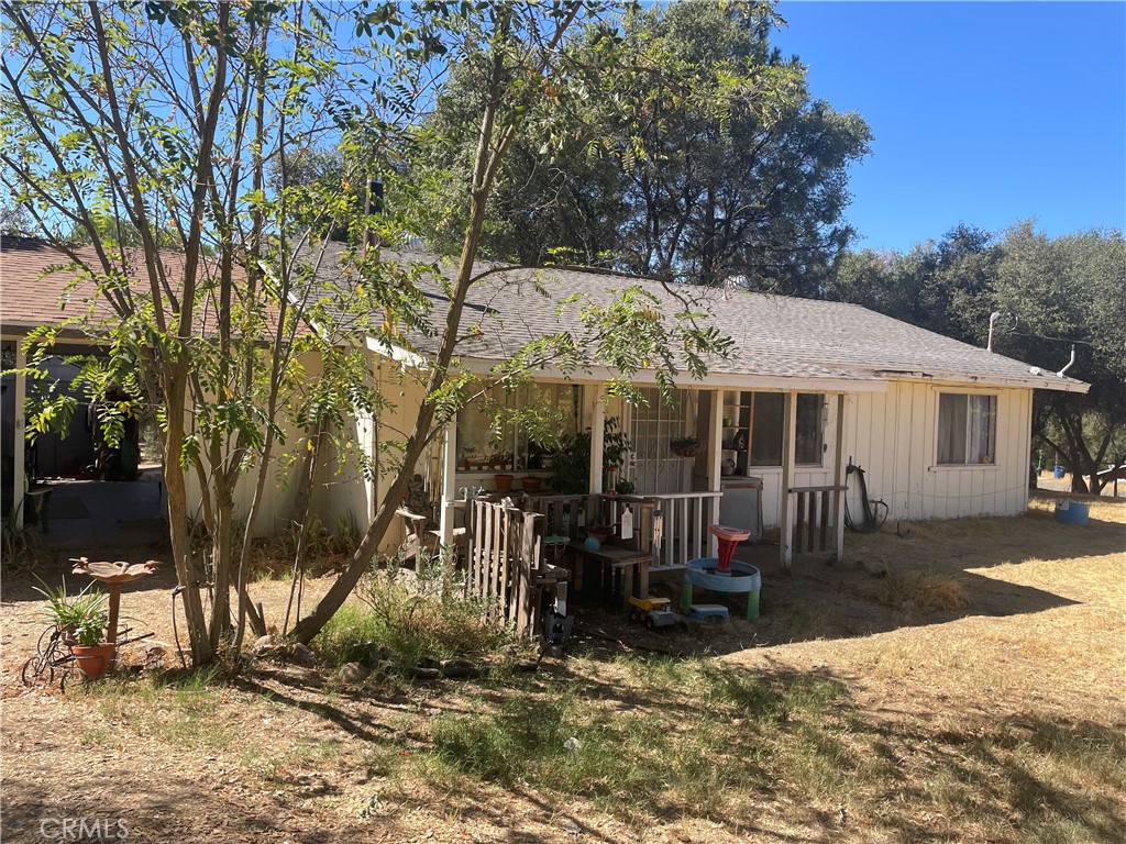 a view of a house with a yard and sitting area