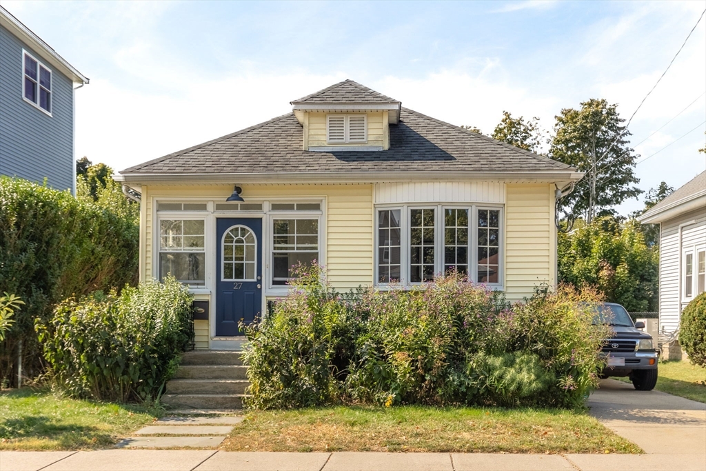 a front view of a house with garden