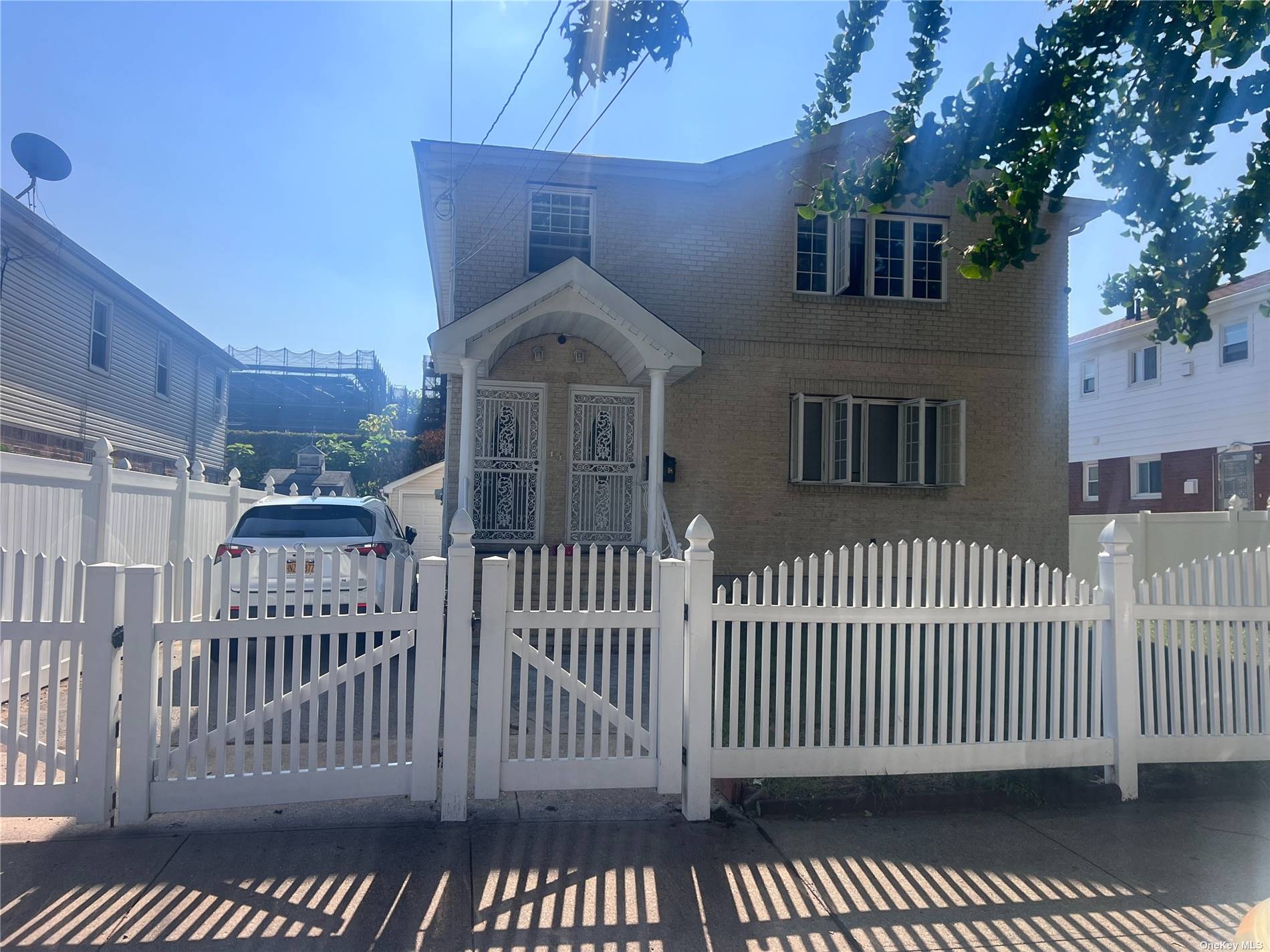 a view of a brick house with wooden fence