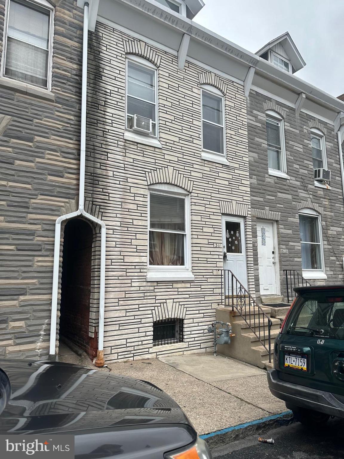 a view of a brick house with many windows