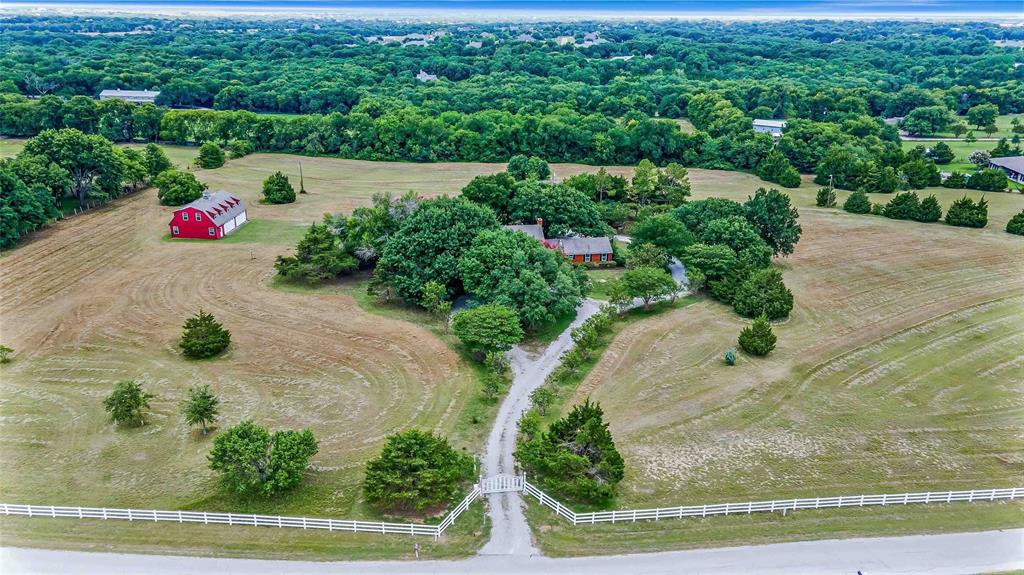 an aerial view of a house with yard