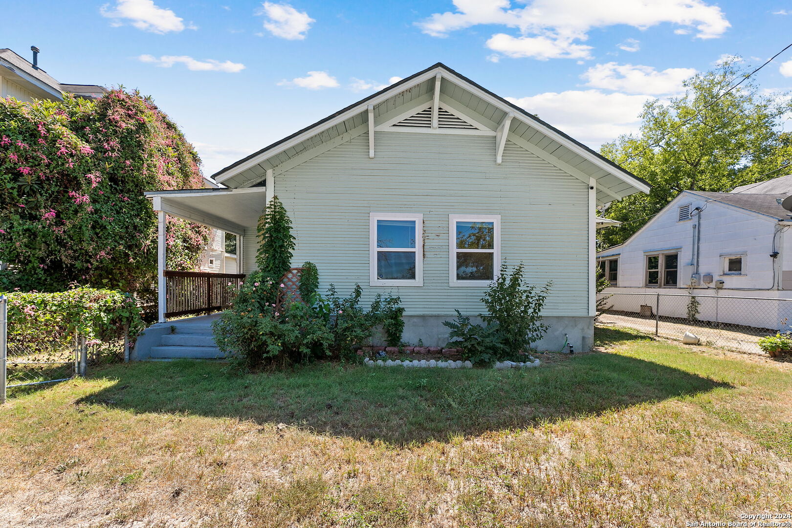 a front view of house with yard and green space