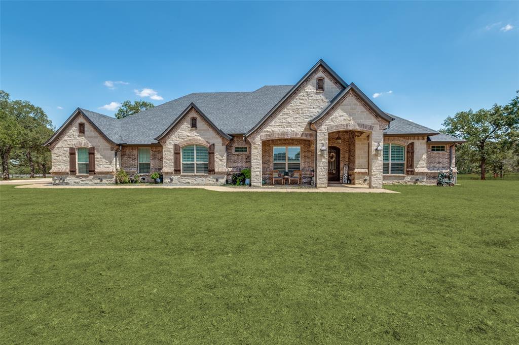 a front view of house with yard and green space