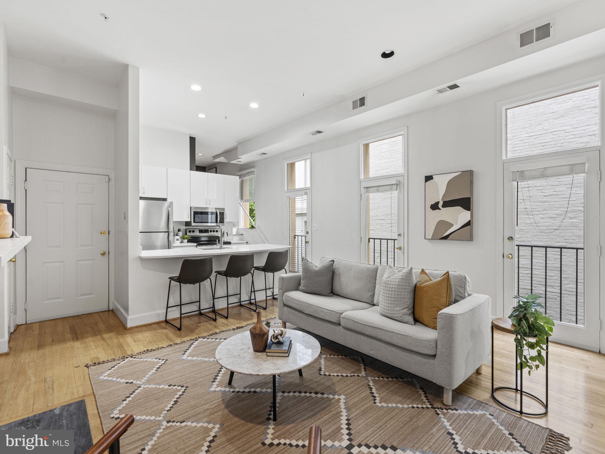 a living room with furniture kitchen view and a table