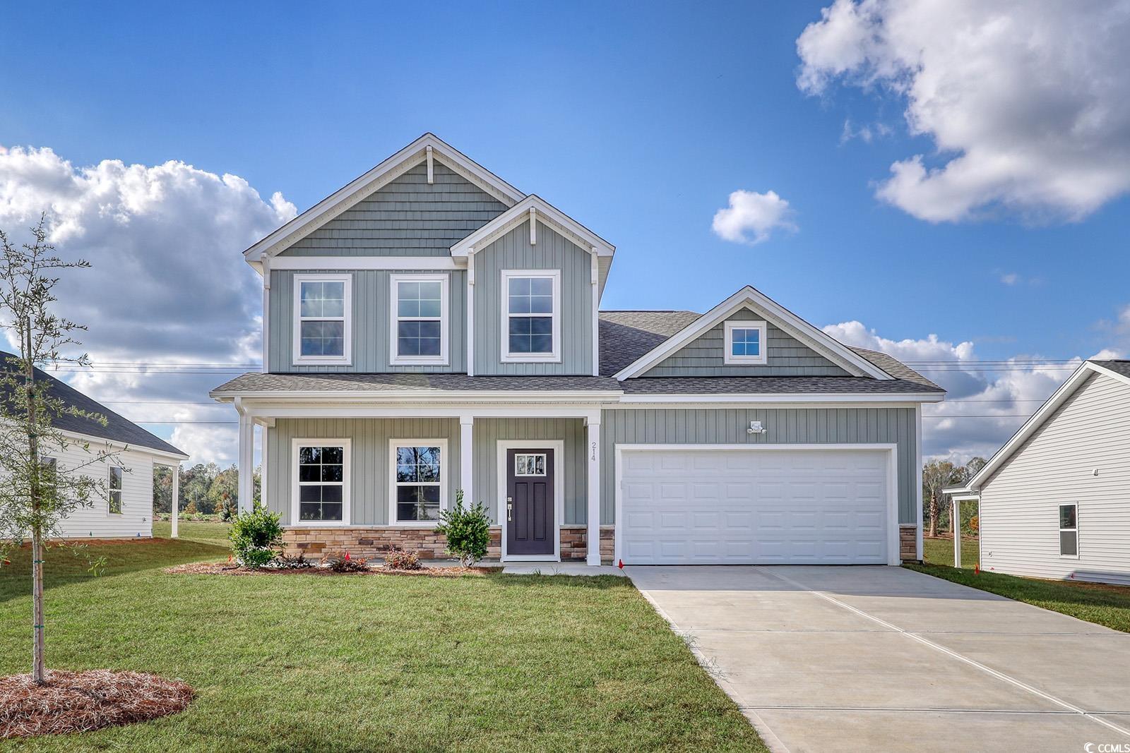 Craftsman-style house with a front yard and a gara