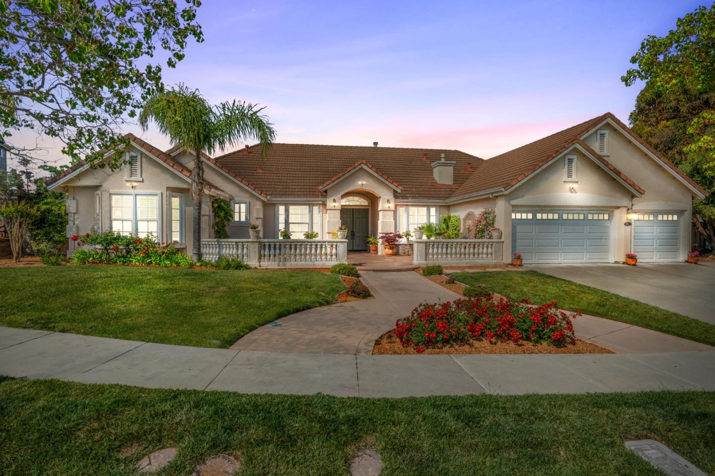 a front view of a house with a garden and yard