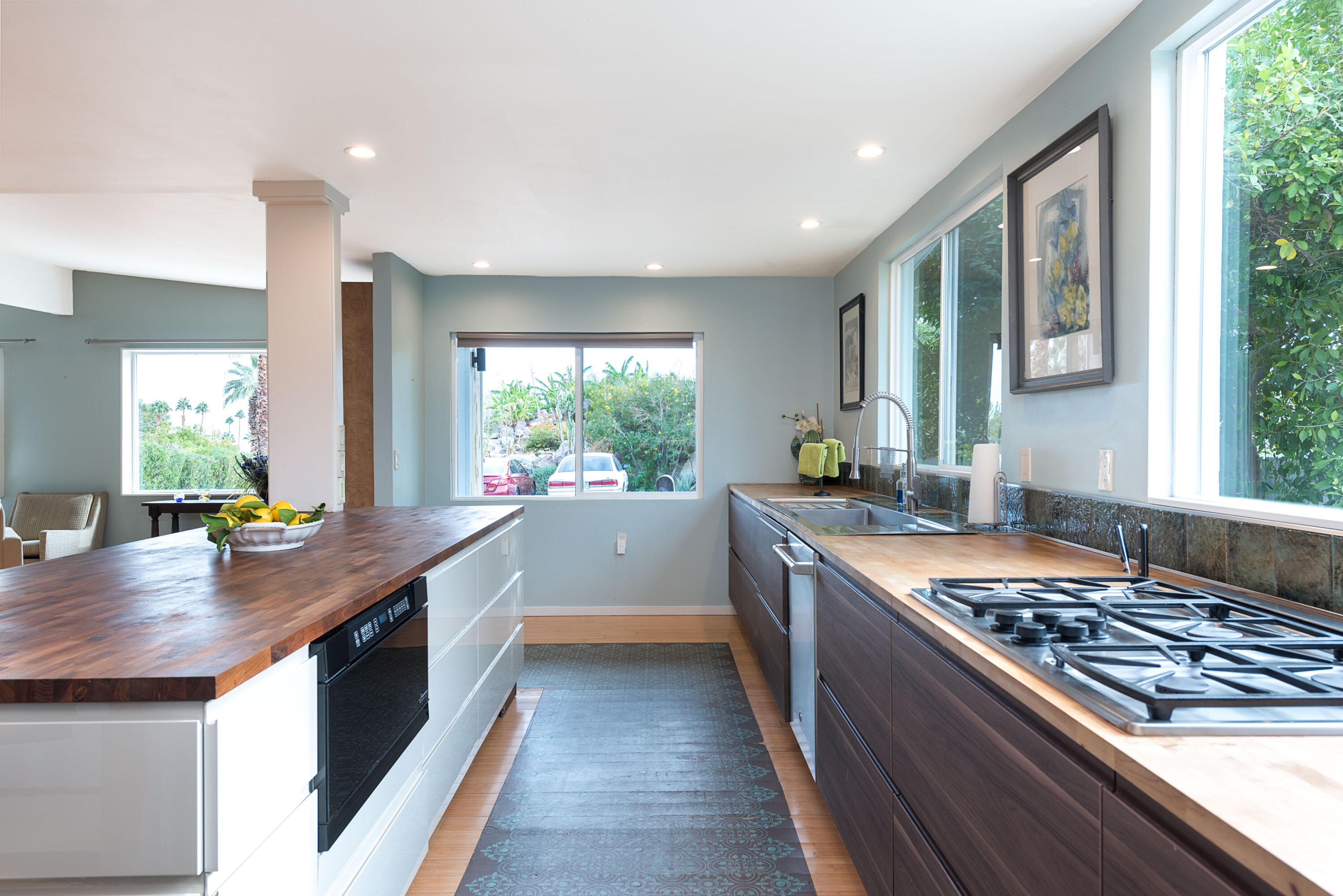 a kitchen with stainless steel appliances granite countertop sink stove and window