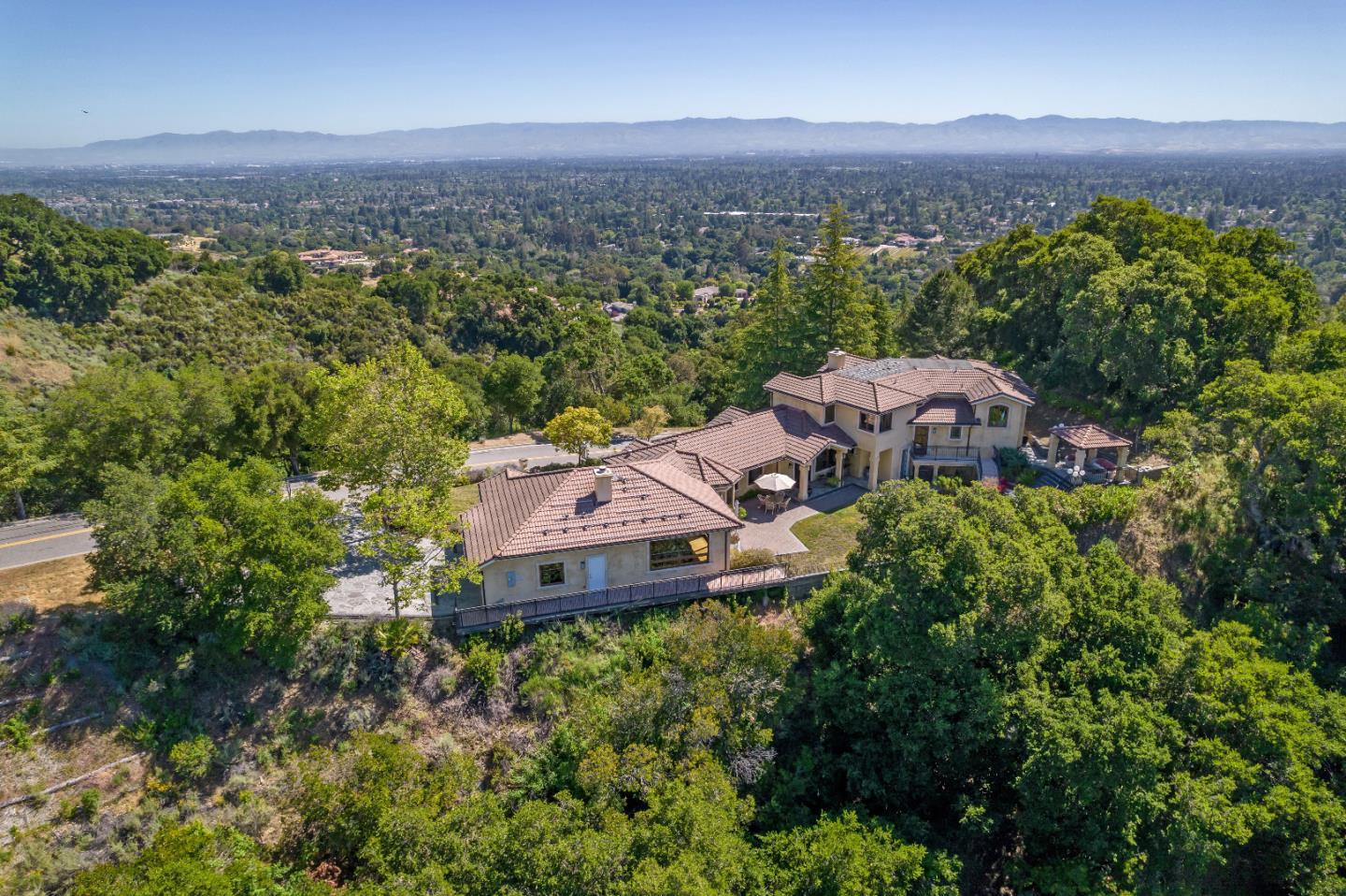 an aerial view of a house with a mountain in the background