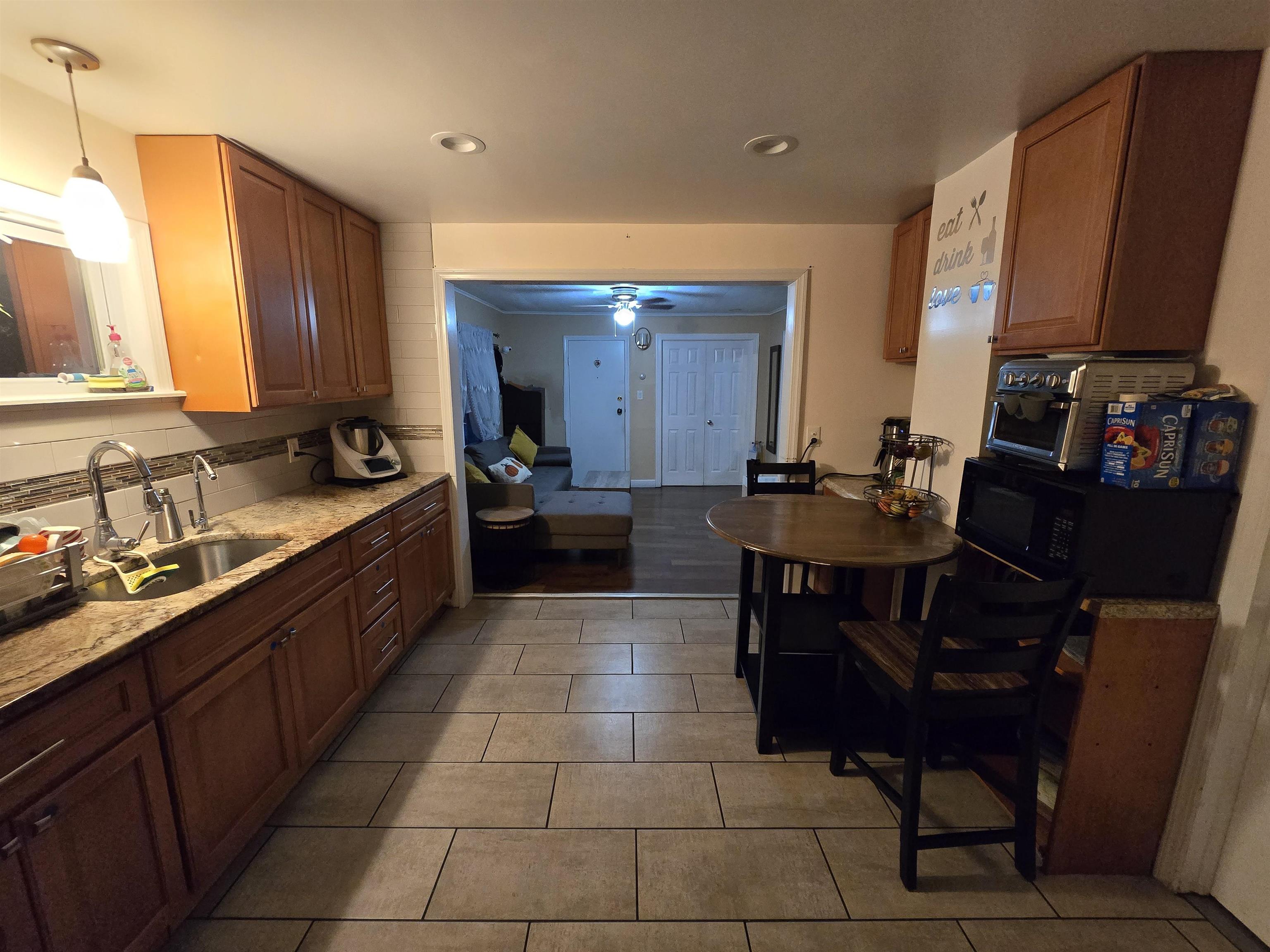 a large kitchen with a table and chairs