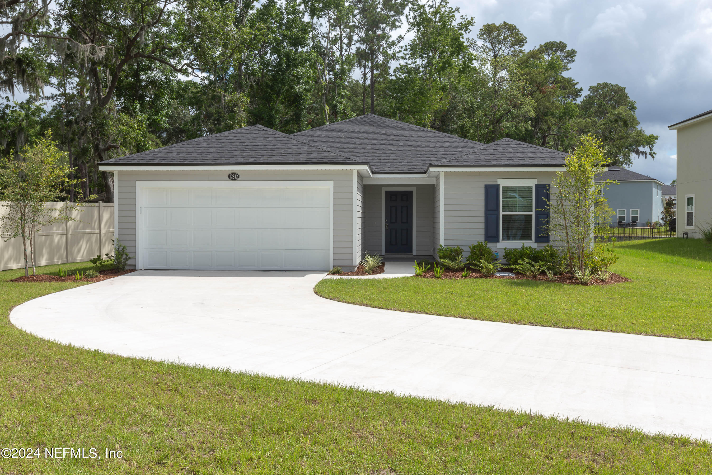 a front view of house with yard and trees