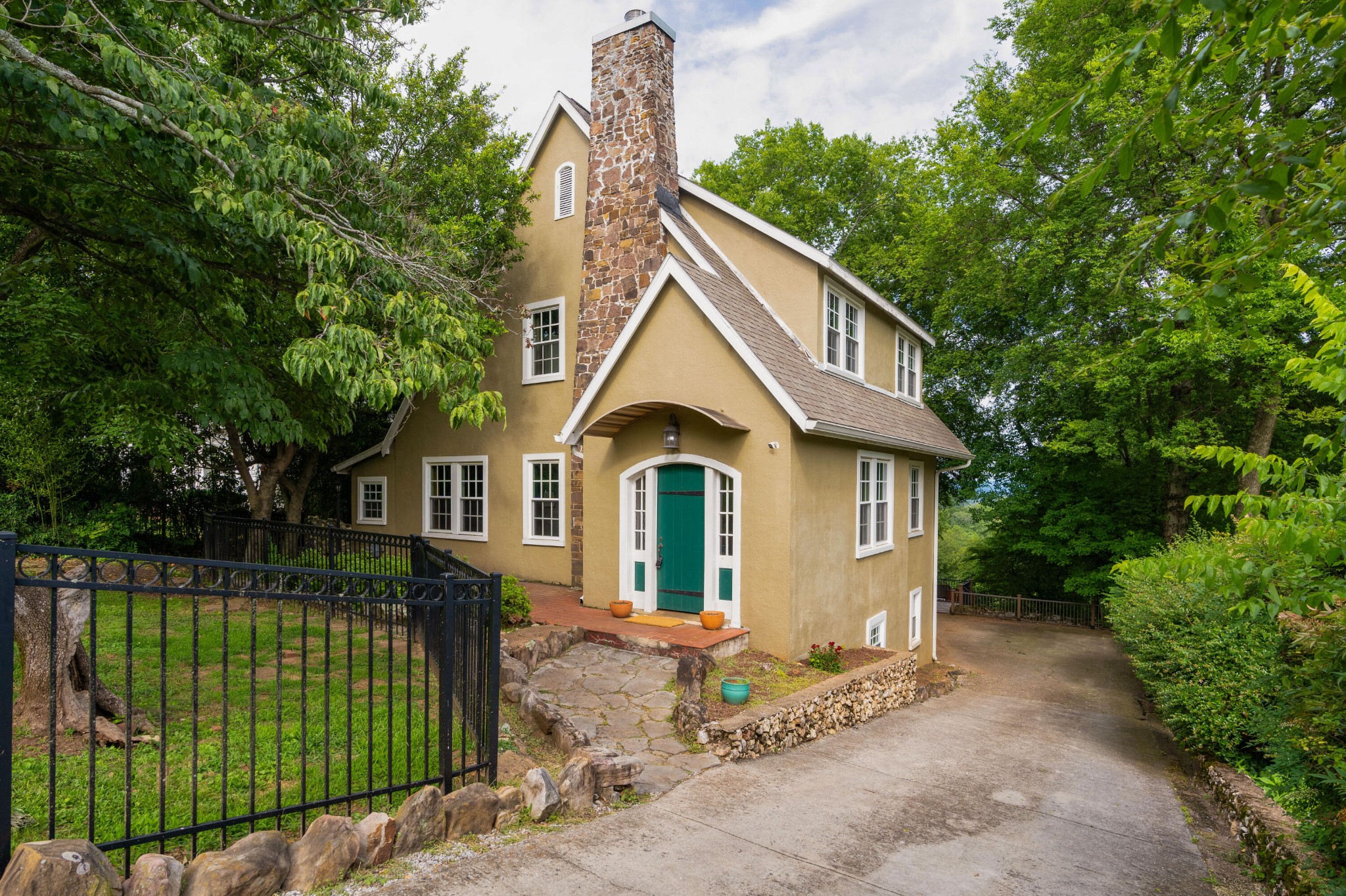 a front view of a house with a garden