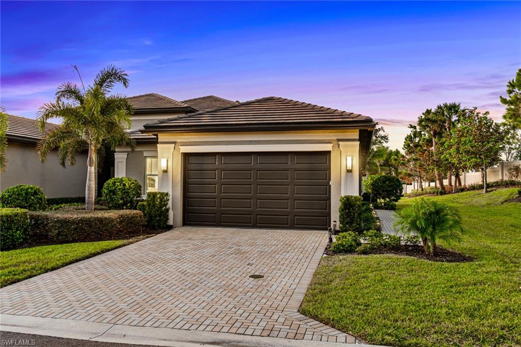 a front view of a house with a yard and garage