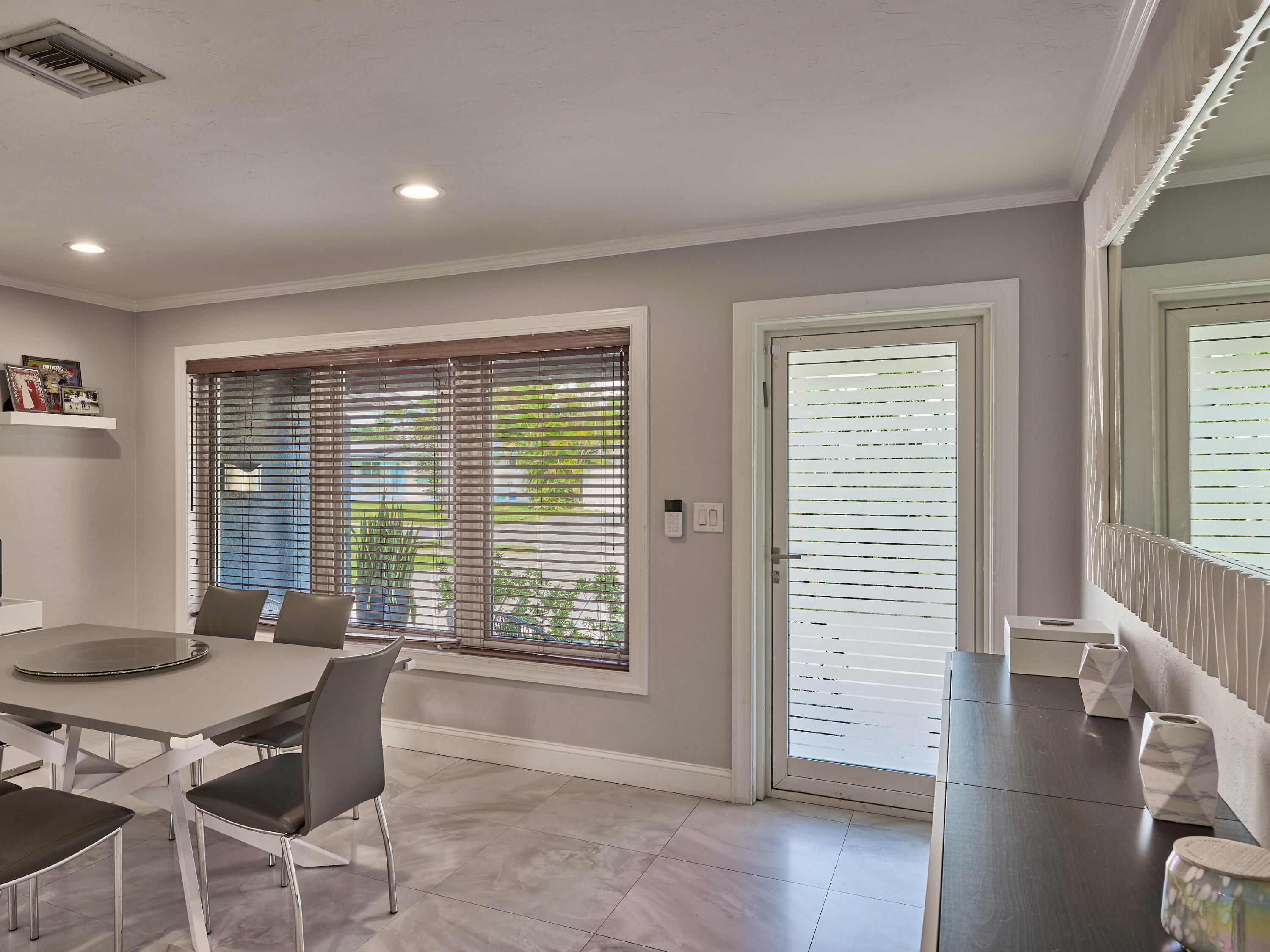 a dining room with furniture and wooden floor