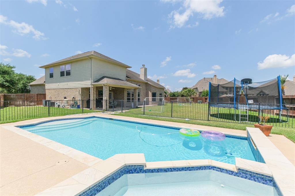 a view of swimming pool with a yard and sitting area