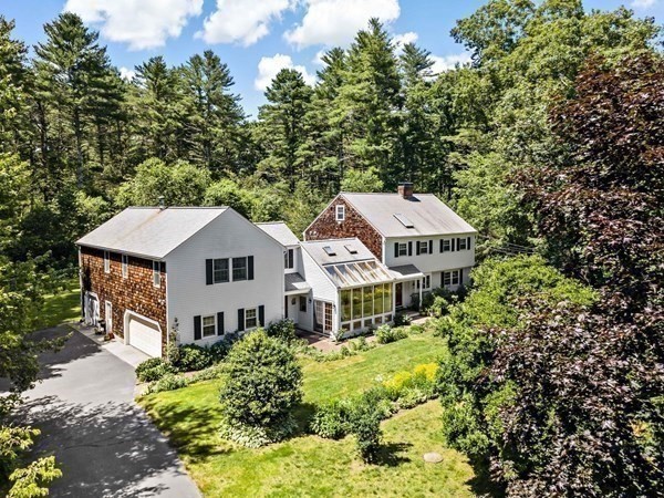 a aerial view of a house with a big yard and large trees