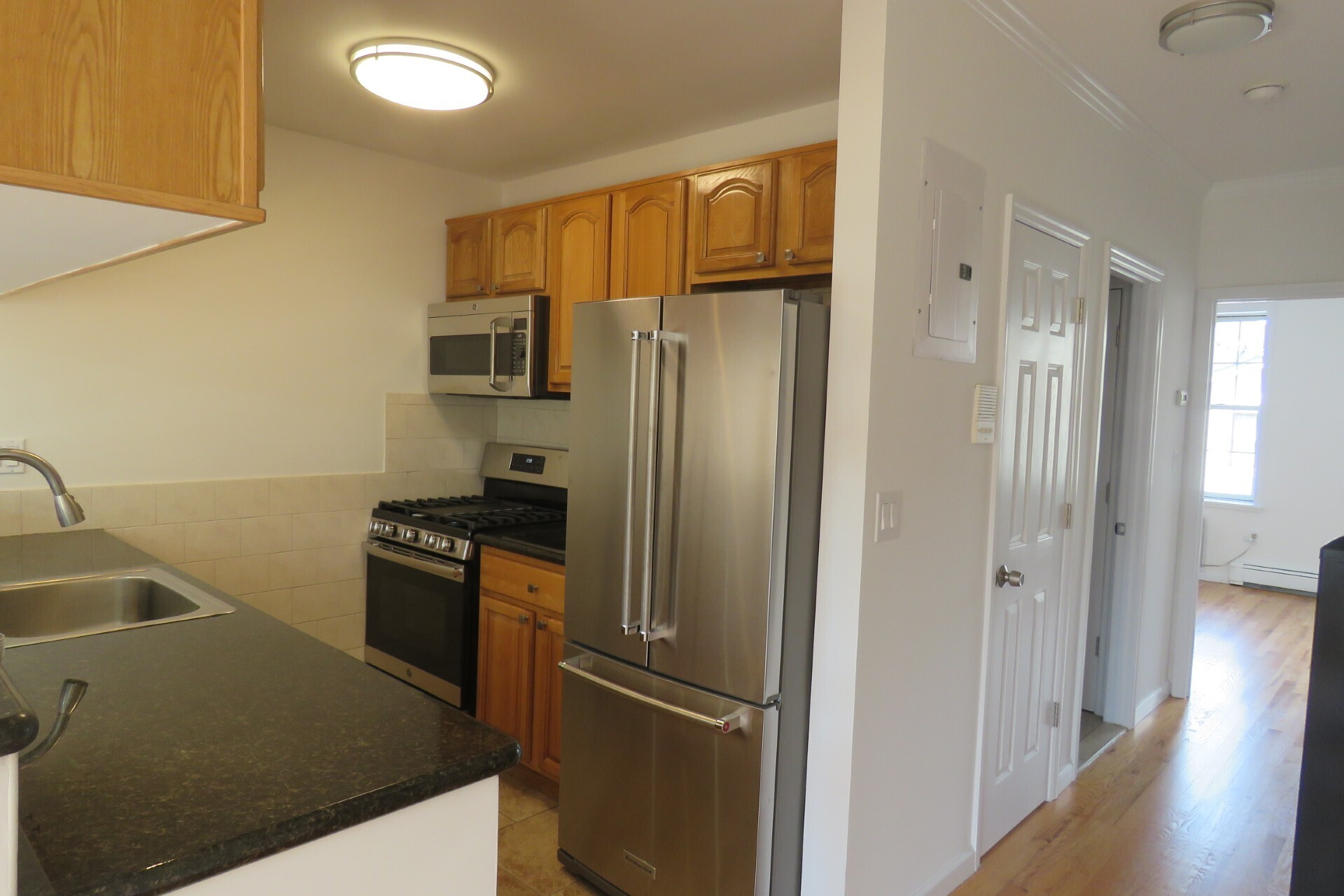 a kitchen with cabinets and stainless steel appliances