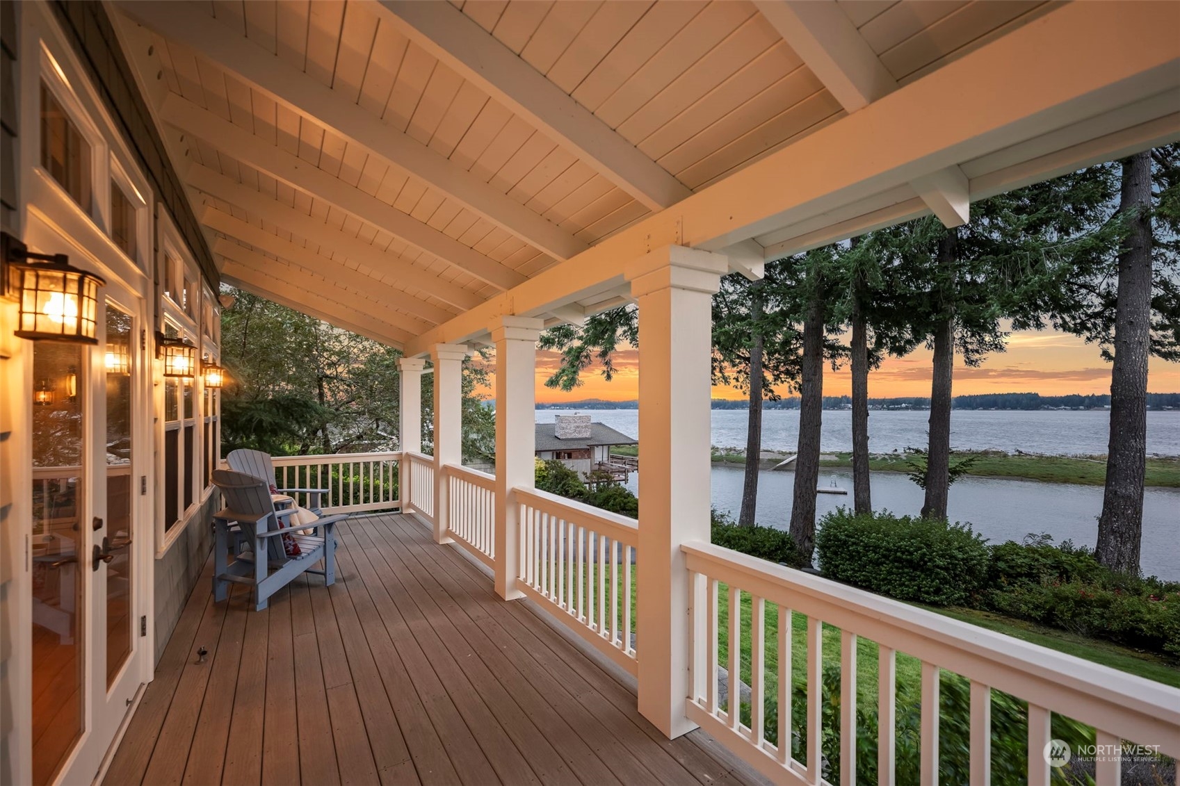 a view of a balcony with chairs and wooden floor