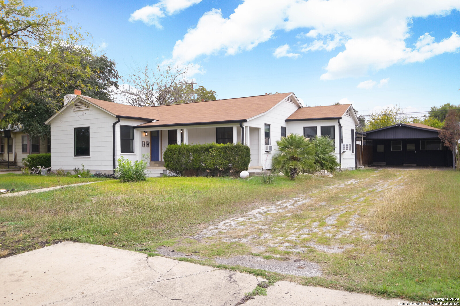 a front view of a house with a garden