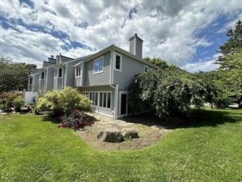 a view of house with yard and green space