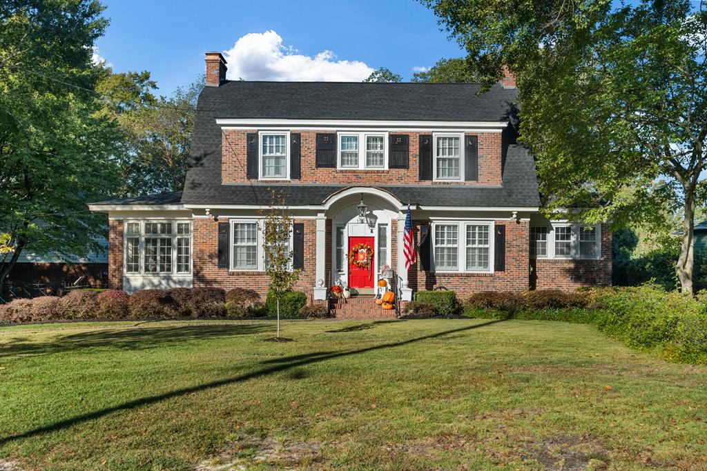 a front view of house with yard and green space