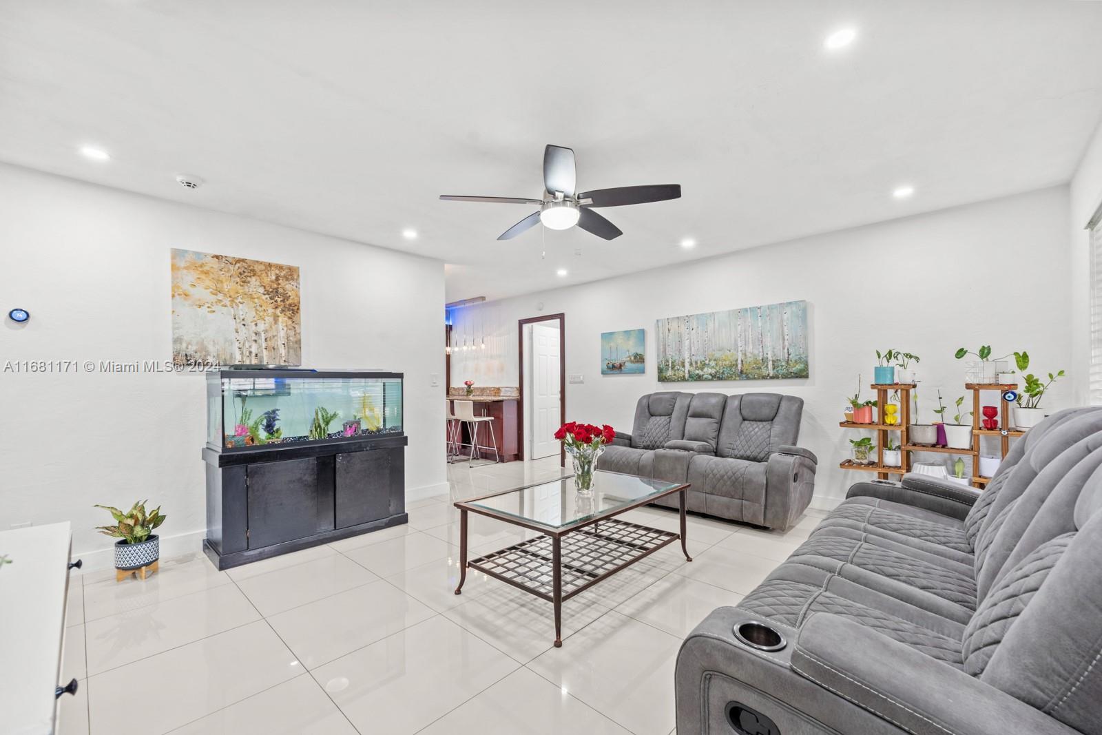 a living room with furniture and kitchen view