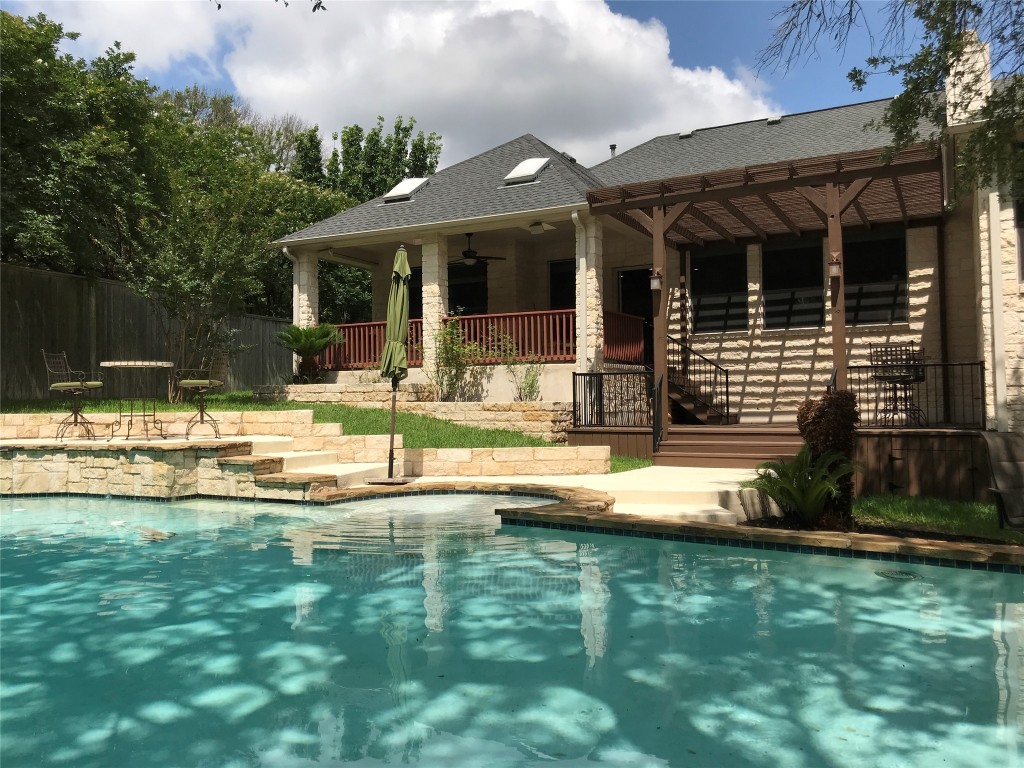 a view of a house with swimming pool and sitting area