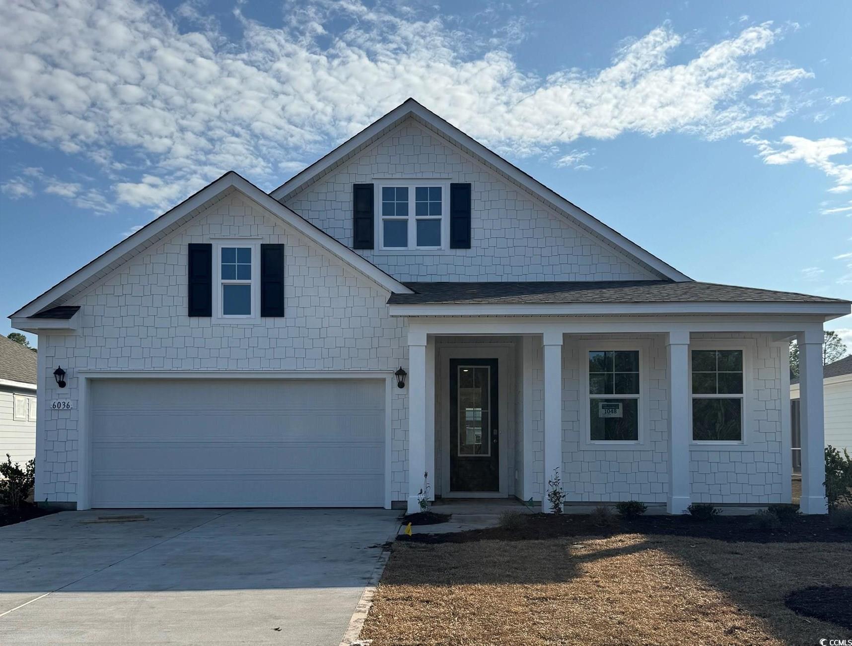 View of front of home featuring a garage, concrete