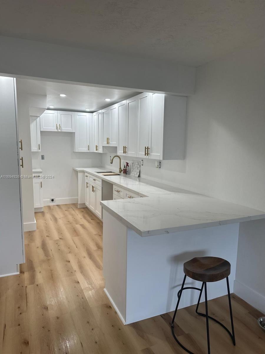 a kitchen with a stove a sink and a refrigerator