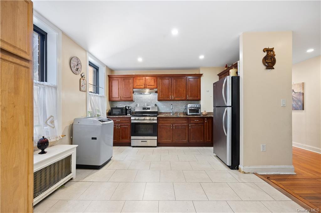 a kitchen with stainless steel appliances granite countertop a refrigerator and a stove