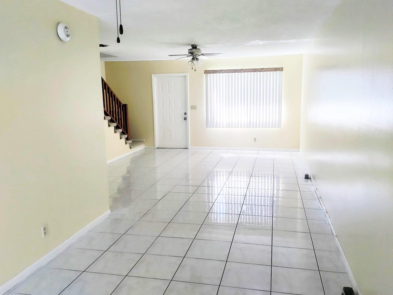 a view of a livingroom with an empty space and a window